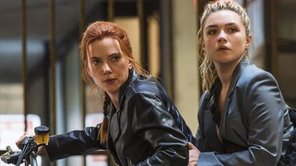 Scarlett Johansson as Natasha Romanoff and Florence Pugh as Yelena Belova sit together on a motorcycle in the movie 'Black Widow'