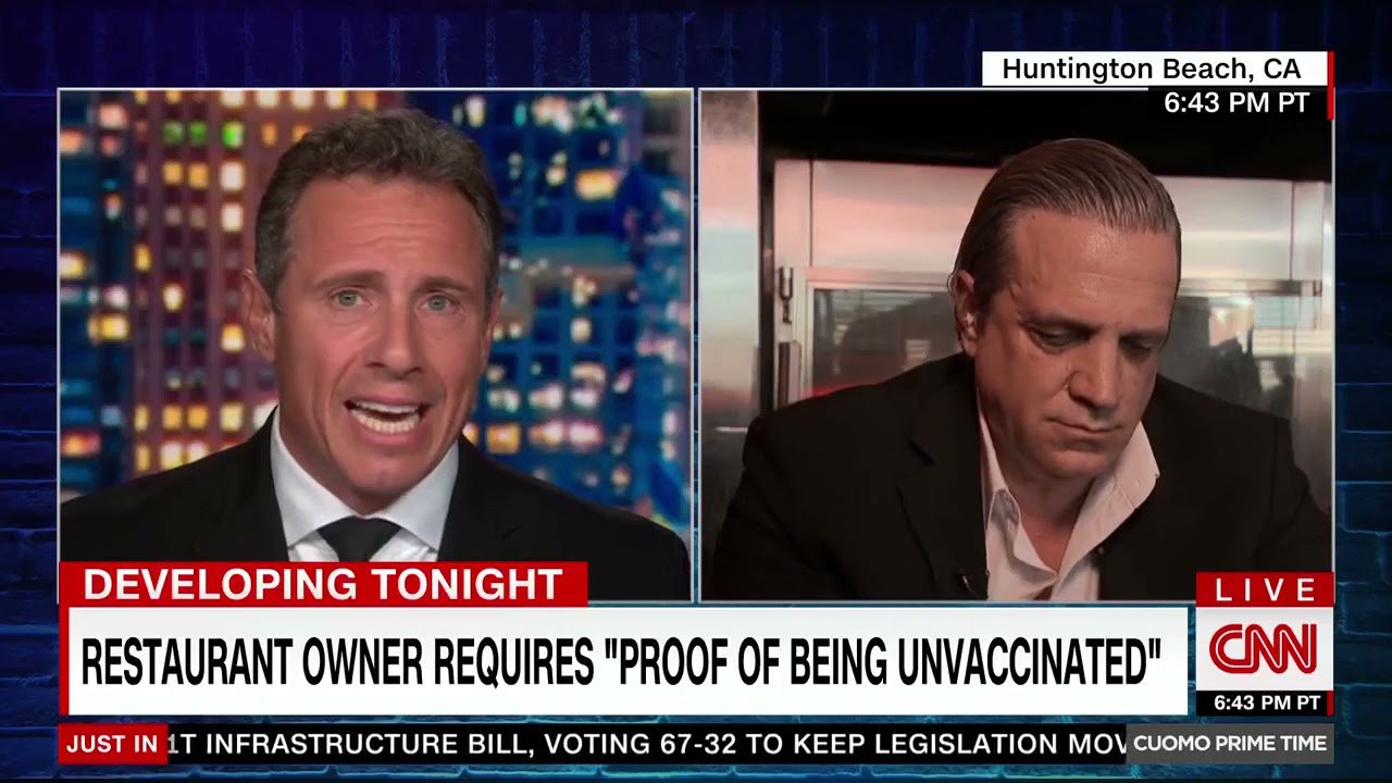 Chris Cuomo interviews a restaurant owner above a chyron reading "restaurant owner requires 'proof of being unvaccinated'"