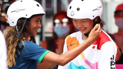Rayssa Leal of Team Brazil puts her hand up to the face of Momiji Nishiya of Team Japan during the Women's Street Final on day three of the Tokyo 2020 Olympic Games