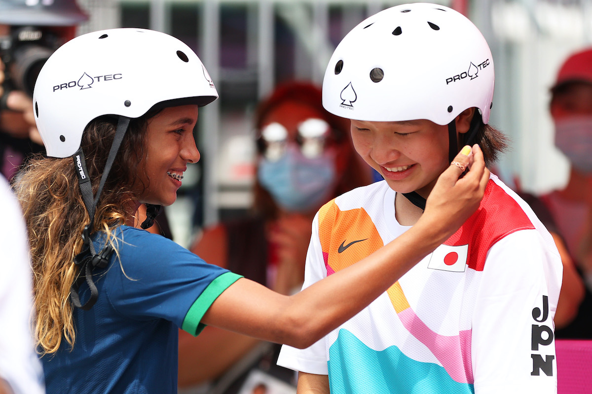 Rayssa Leal of Team Brazil puts her hand up to the face of Momiji Nishiya of Team Japan during the Women's Street Final on day three of the Tokyo 2020 Olympic Games
