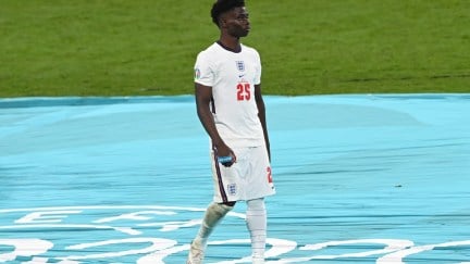 ONDON, ENGLAND - JULY 11: Bukayo Saka of England looks dejected after receiving his runners up medal following defeat in the UEFA Euro 2020 Championship Final between Italy and England at Wembley Stadium on July 11, 2021 in London, England. (Photo by Facundo Arrizabalaga - Pool/Getty Images)