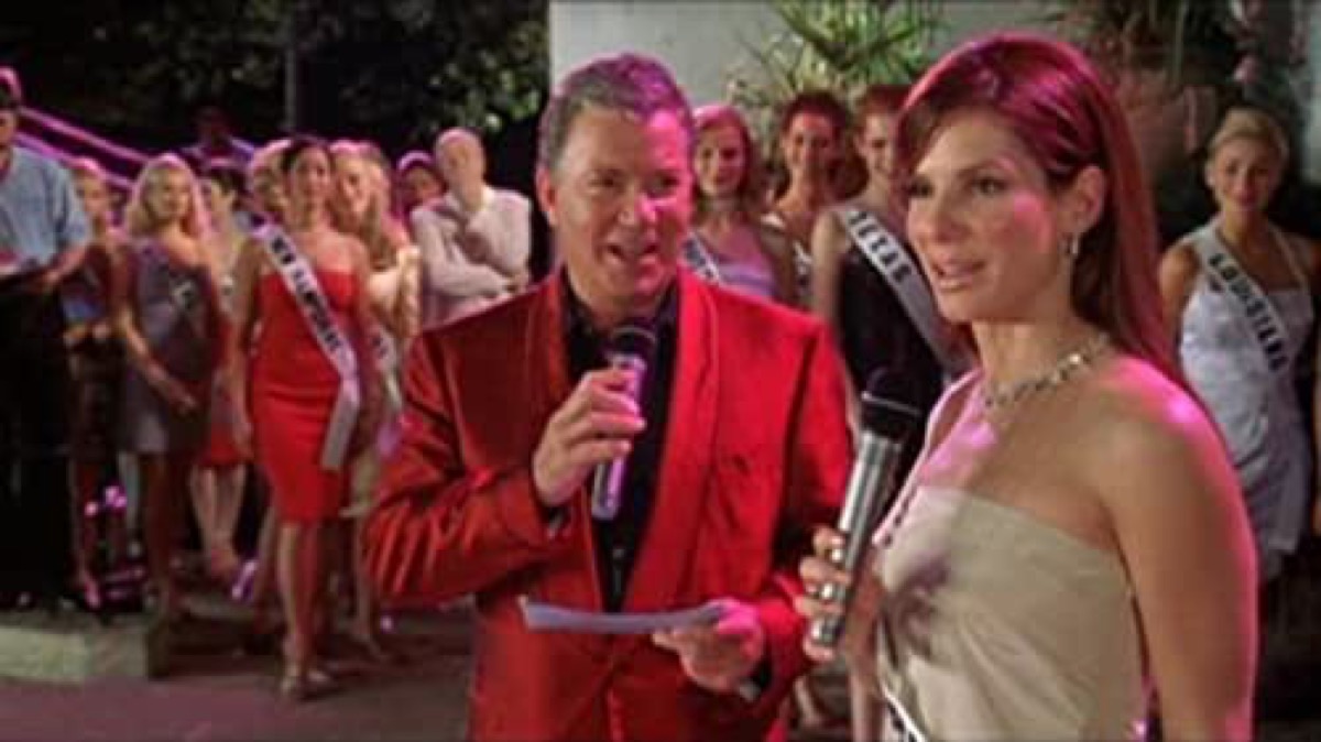 Sandra Bullock speaks into a microphone on pageant stage in Miss Congeniality.
