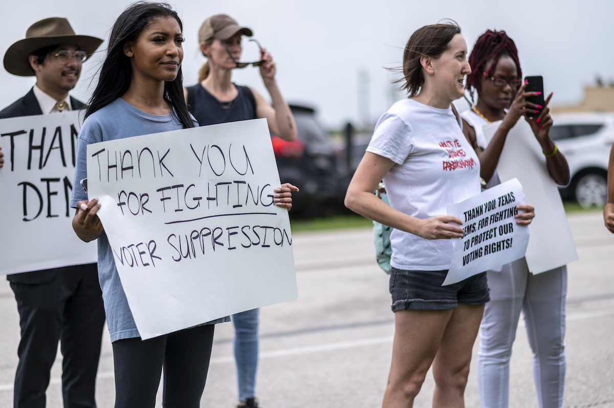 Supporters for Texas Democrats stand outside the Austin Bergstrom International Airport on July 12, 2021