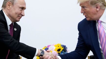 Donald Trump and Vladimir Putin shake hands