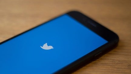 The Twitter logo is seen on a phone in this photo illustration in Washington, DC, on July 10, 2019. - Twitter is moving to filter out inappropriate content based on religion as part of its effort to curb hate speech. In a policy update on July 9, 2019, Twitter said it would take down 