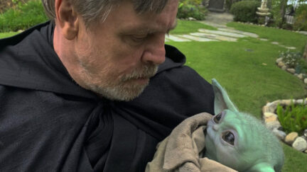 Mark Hamill holding Grogu.