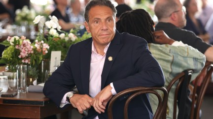 Andrew Cuomo sits at a dinner table at the Tribeca Film Festival