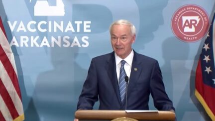 Arkansas Governor Asa Hutchinson speaks from a podium during a news conference