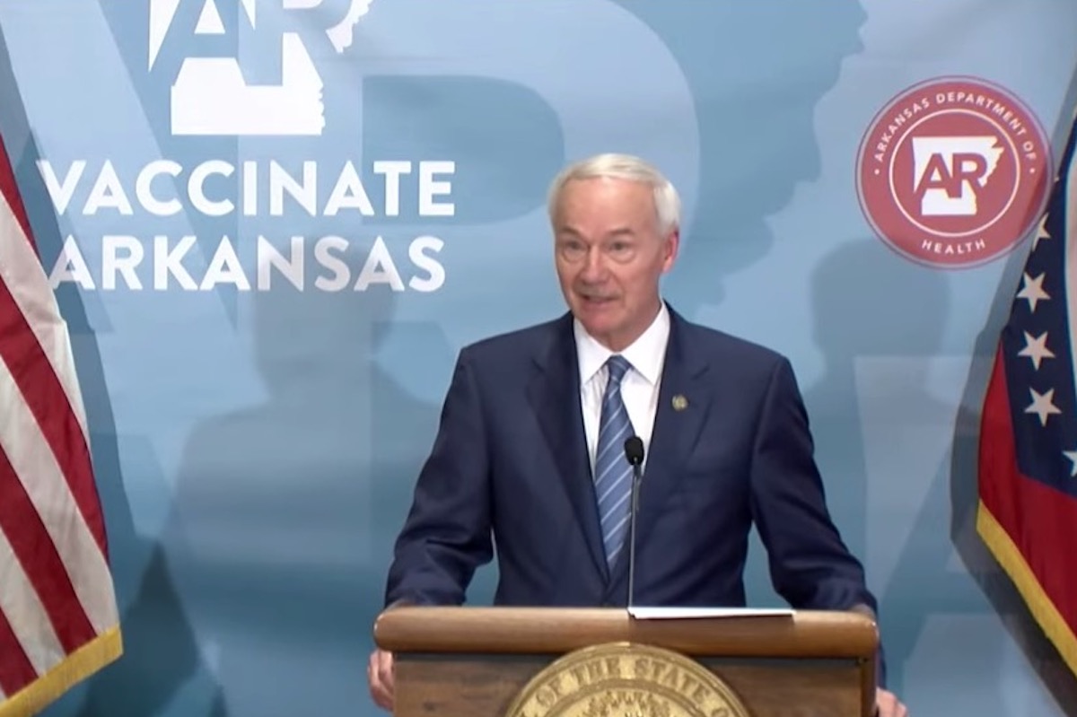 Arkansas Governor Asa Hutchinson speaks from a podium during a news conference