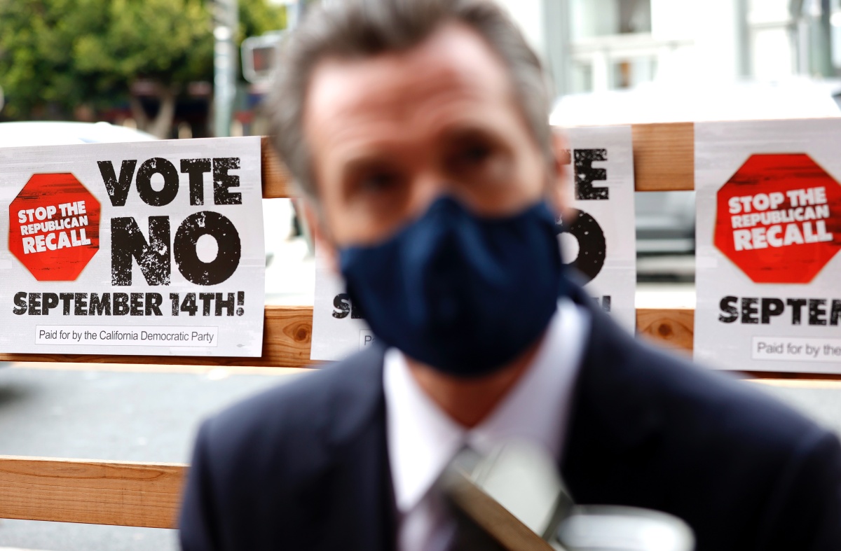 SAN FRANCISCO, CALIFORNIA - AUGUST 13: A sign against the recall is posted behind California Gov. Gavin Newsom as he talks with volunteers who are phone banking against the recall at Manny's on August 13, 2021 in San Francisco, California. California Gov. Gavin Newsom kicked off his "Say No" to recall campaign as he prepares to face a recall election on September 14. (Photo by Justin Sullivan/Getty Images)