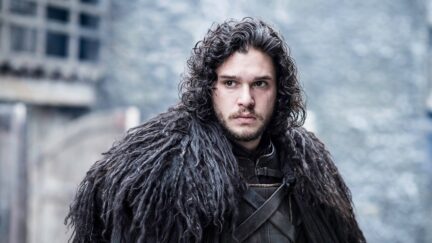 kit harington in a fur cloak as jon snow in game of thrones