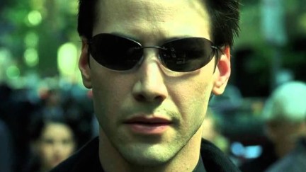 Keanu Reeves wearing sunglasses as Neo in 'The Matrix'