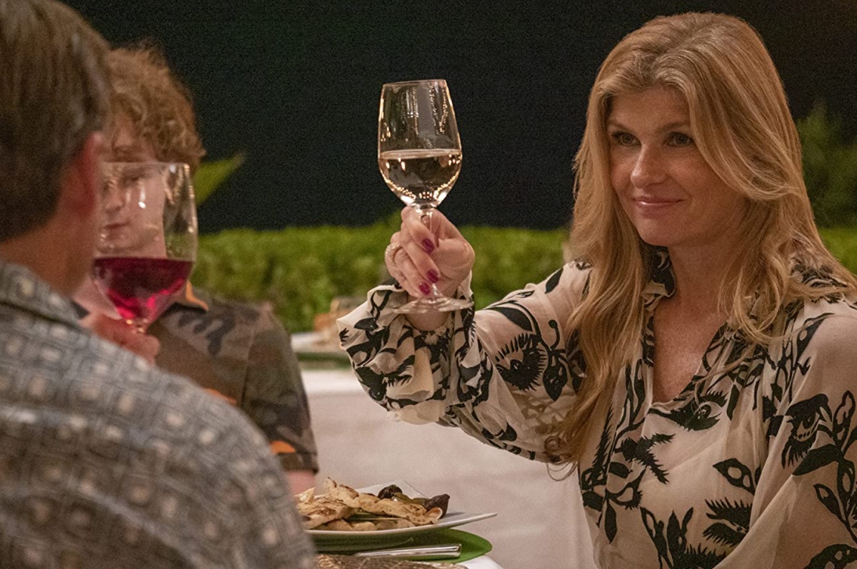 Connie Britton raising a wine glass in The White Lotus (2021)