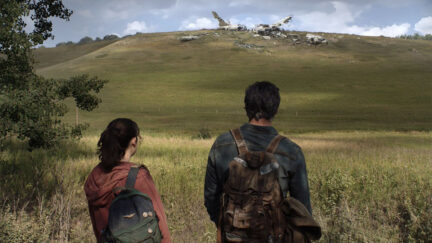 Pedro Pascal and Bella Ramsey looking out at a field in HBO's The Last of Us