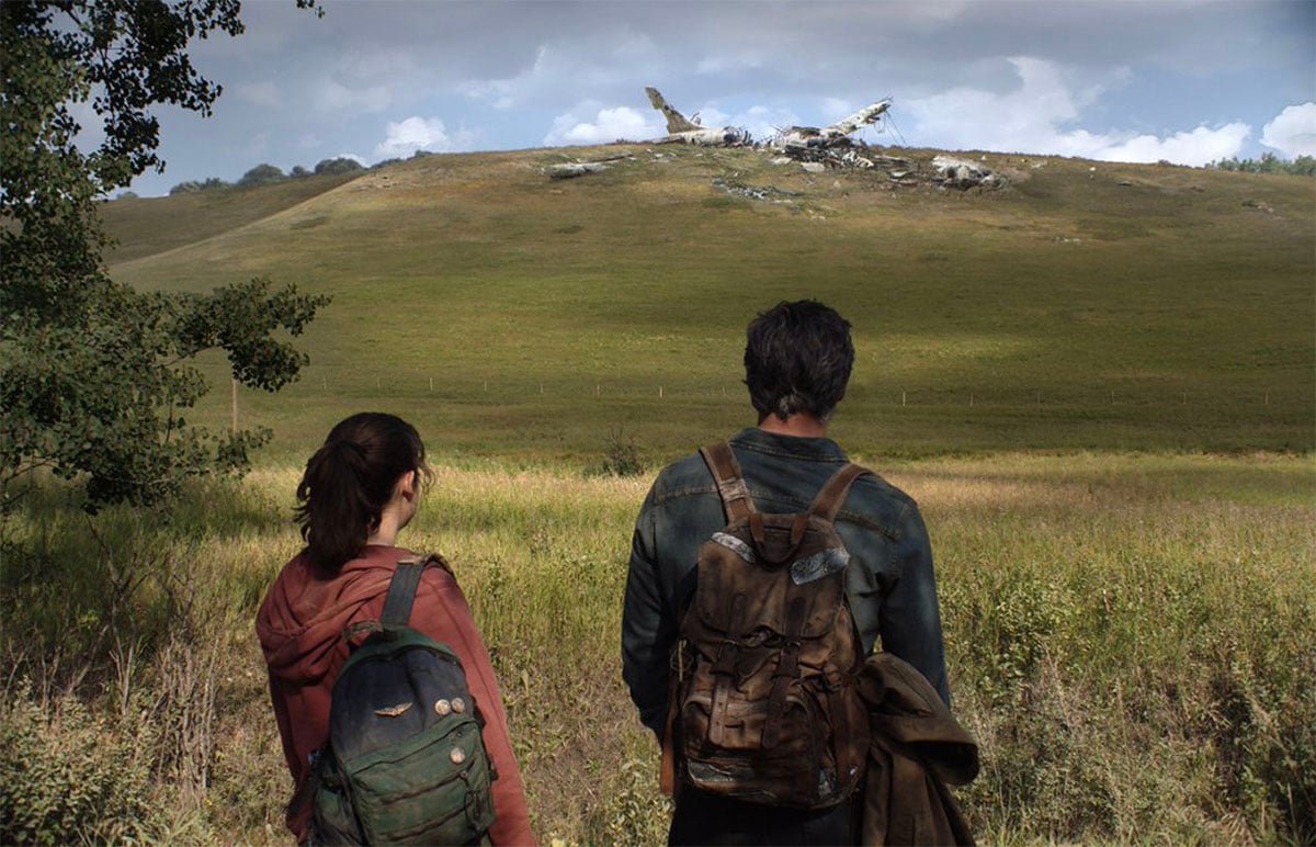 Pedro Pascal and Bella Ramsey looking out at a field in HBO's The Last of Us