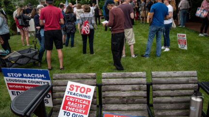 Signs are seen on a bench during a rally against 