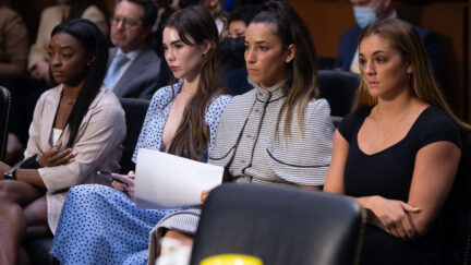 US gymnasts (L-R) Simone Biles, McKayla Maroney, Aly Raisman and Maggie Nichols sit next to each other before testifying during a Senate Judiciary hearing