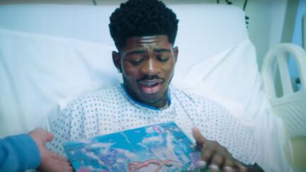 Lil Nas X holding his child for the first time. (Image: Lil Nas X and Columbia Records.)