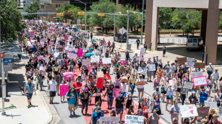 Hundreds of protesters march down a street in Texas