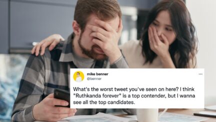 A man and a woman look away from a phone in horror