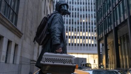 Yorick masked up (a vibe) holding his pet crate. (Image: FX/Hulu.)