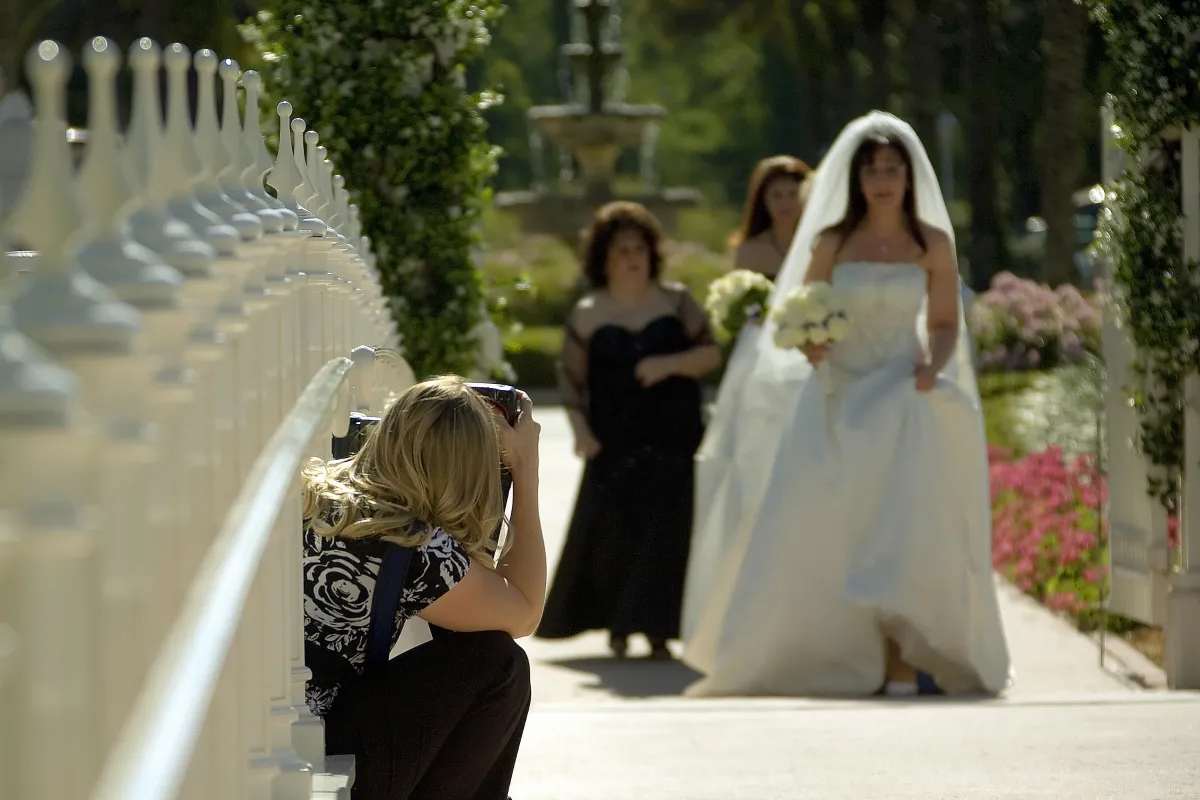 A picture of a photographer photographing a bride