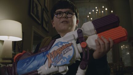 Archie Yates holding a toy gun in the trailer for Home Sweet Home Alone