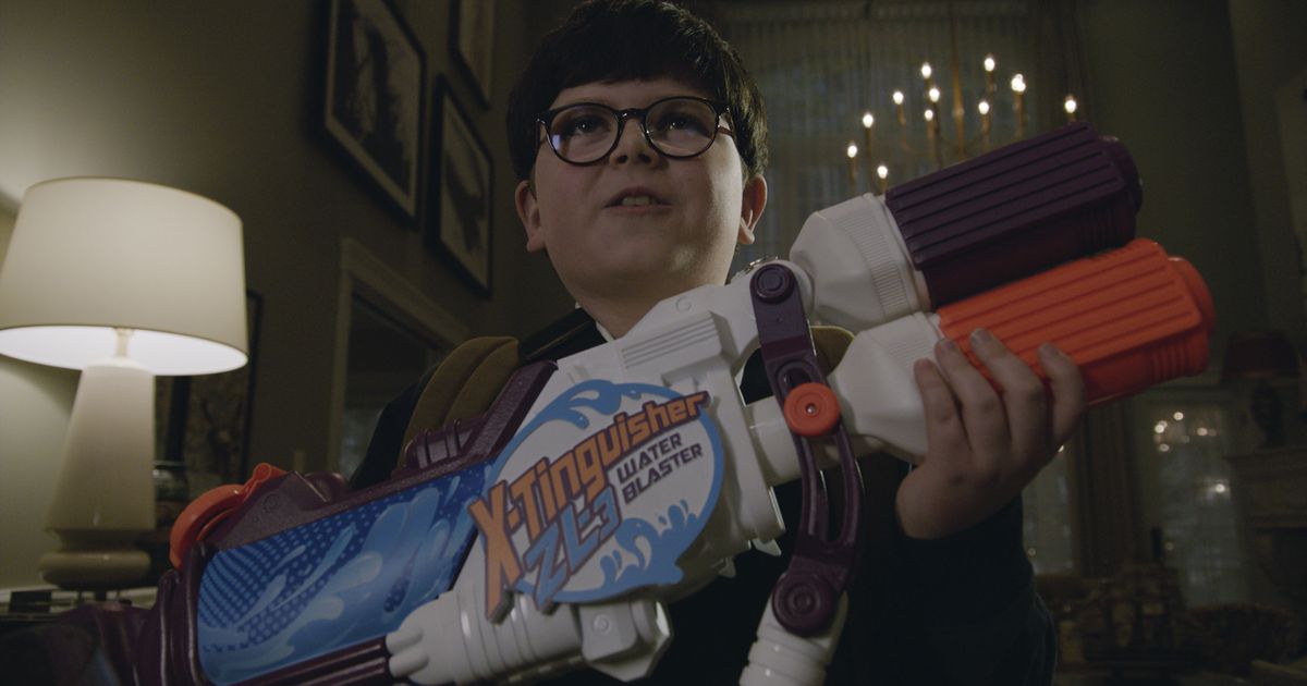 Archie Yates holding a toy gun in the trailer for Home Sweet Home Alone