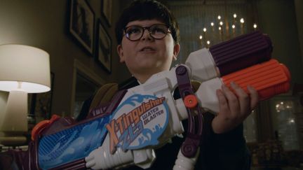 Archie Yates holding a toy gun in the trailer for Home Sweet Home Alone