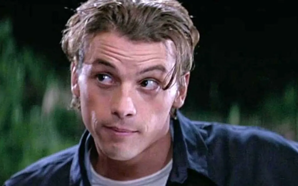 Skeet Ulrich smirks as Billy in a scene from Scream.