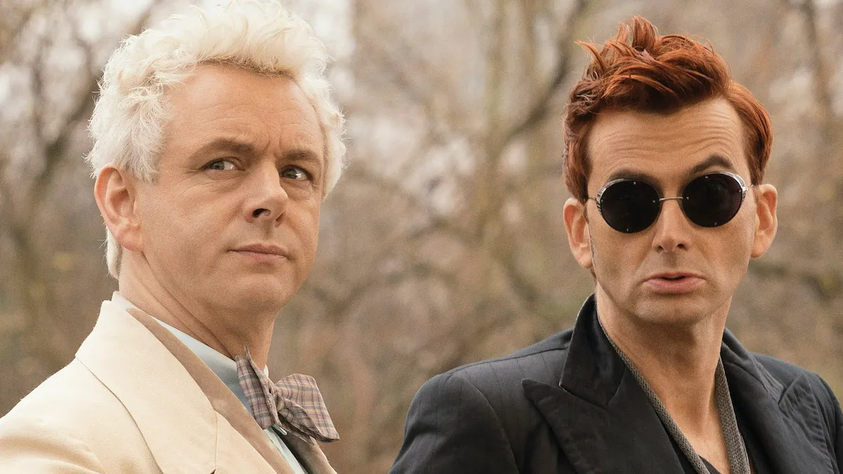 Michael Sheen as the angel Aziraphale sits next to David Tennant in sunglasses as the demon Crowley in 'Good Omens'