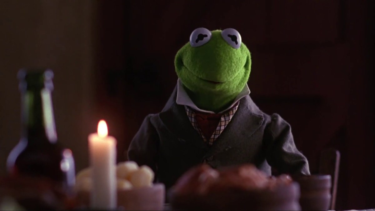 Kermit the Frog at a table in the Muppet Christmas Carol 
