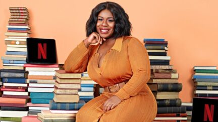 Netflix Book Club with Uzo Aduba promotional image. Uzo smiling over a bunch of books. (Image: Netflix.)