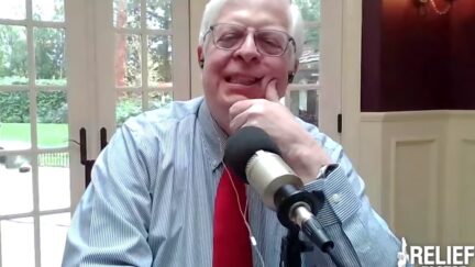 Dennis Prager rubs his face while speaking on his radio show