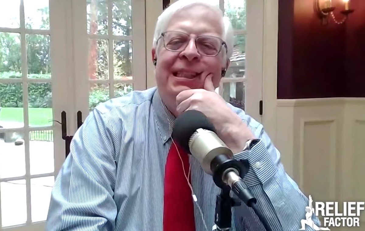 Dennis Prager rubs his face while speaking on his radio show