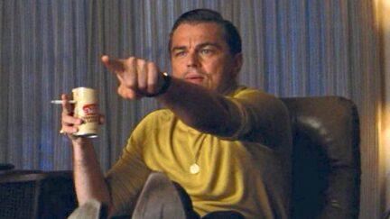 Leonardo DiCaprio in a yellow shirt pointing as Rick Dalton in the movie 'Once Upon a TIme in Hollywood'