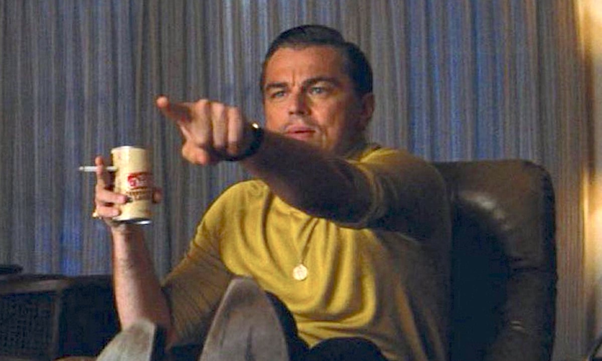 Leonardo DiCaprio in a yellow shirt pointing as Rick Dalton in the movie 'Once Upon a TIme in Hollywood'