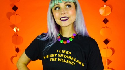 A woman wears a black Super Yaki t-shirt that says 