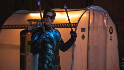 nightwing in titans showing off his second best asset his sticks