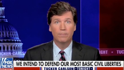 Tucker Carlson speaks during his Fox News show abover a chyron reading 