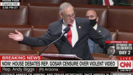 Rep. Andy Biggs throws his arms wide while speaking from the House floor.