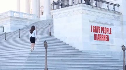 Representative Lauren Boebert walking up steps next to the phrase 