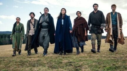 Cast of Amazon's Wheel of Time walking in a field in the show.