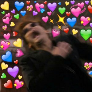 David Tennant clutches his chest as Crowley in Good Omens surrounded by hearts in a reaction meme
