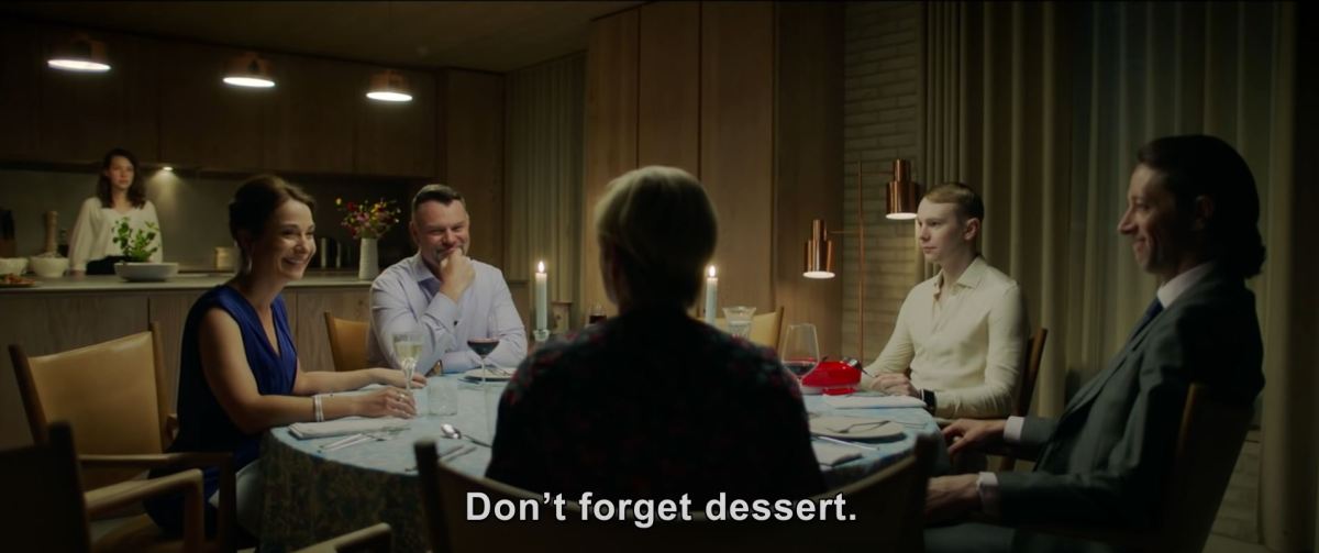 The Feast - everyone easting over the text "Don't forget dessert." Screencap from trailer. (Image: IFC.)