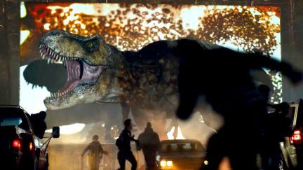 a t-rex destroying a drive in in jurassic world dominion