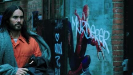 Jared Leto as Morbius walking by a Spider-Man graffiti