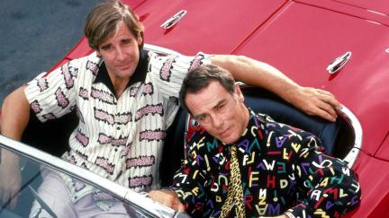 Scott Bakula and Dean Stockwell sit in a red car to promote Quantum Leap