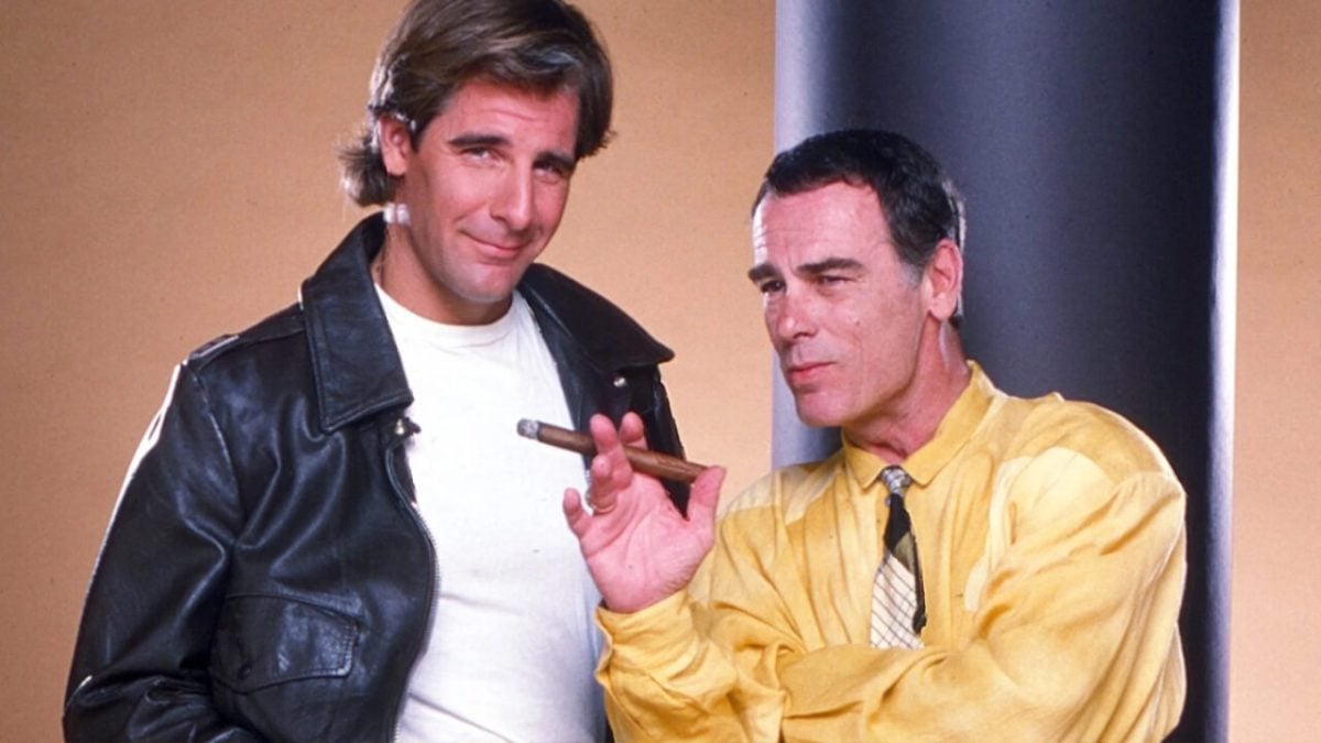 Scott Bakula in a leather jacket and Dean Stockwell holding a cigar to promote Quantum Leap