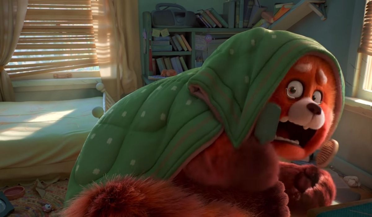 Red panda crying under a blanket. screencap from trailer. (Image: Disney/Pixar.)